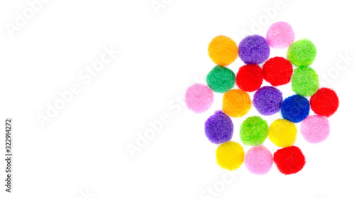 Colored pom pom, party and sewing decoration. Isolated on white.