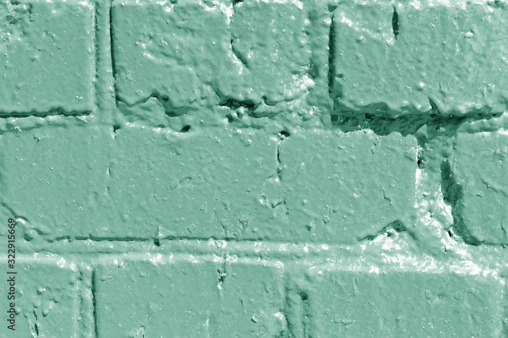 Painted brick wall close up. Abstract background green color toned