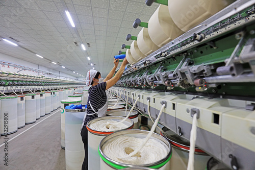 Workers on the spinning line in the spinning mill, Luannan County, Hebei Province, China