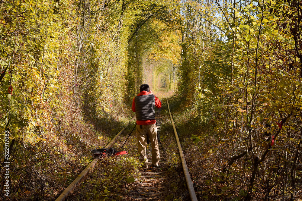 Naklejka premium Photographer taking shots of famous love tunnel in autumn on a sunny day