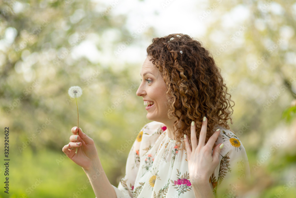 Pretty girl blowing dandelion in summer park. Green grass beautiful nature. Pure emotion. Pretty girl blowing dandelion in summer park. Green grass beautiful nature. Pure emotion.