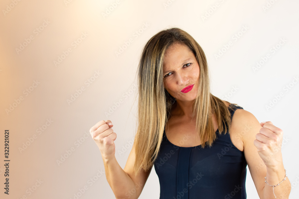 Woman in blue shirt with fist closed