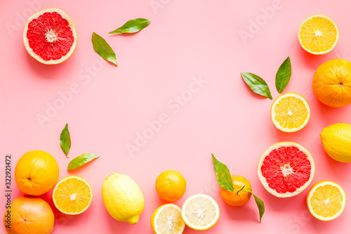 Fototapeta Naklejka Na Ścianę i Meble -  Fresh citrus frame. Oranges, tangerines, grapefruits, leaves on pink background top-down copy space