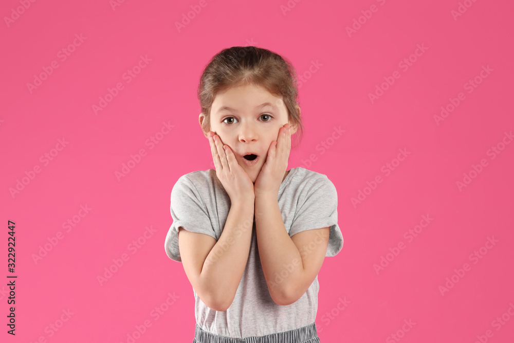 Portrait of shocked little girl on pink background Portrait of shocked little girl on pink background