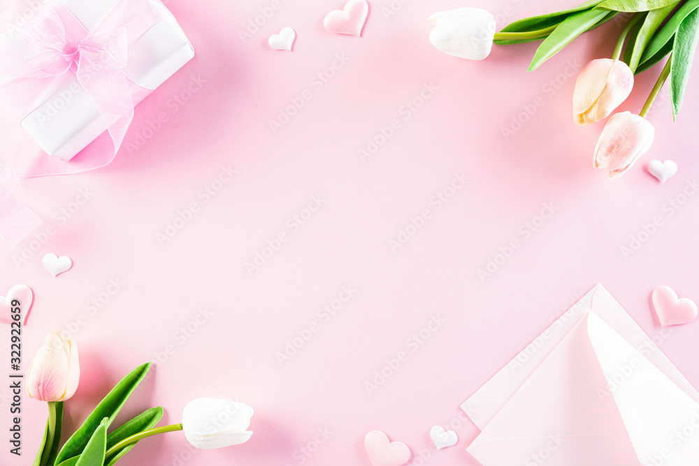 International Women's Day concept. Pink and white tulips with gift box and paper tag text on pink pastel background. Top view flat lay, March 8. International Women's Day concept. Pink and white tulips with gift box and paper tag text on pink pastel background. Top view flat lay, March 8.