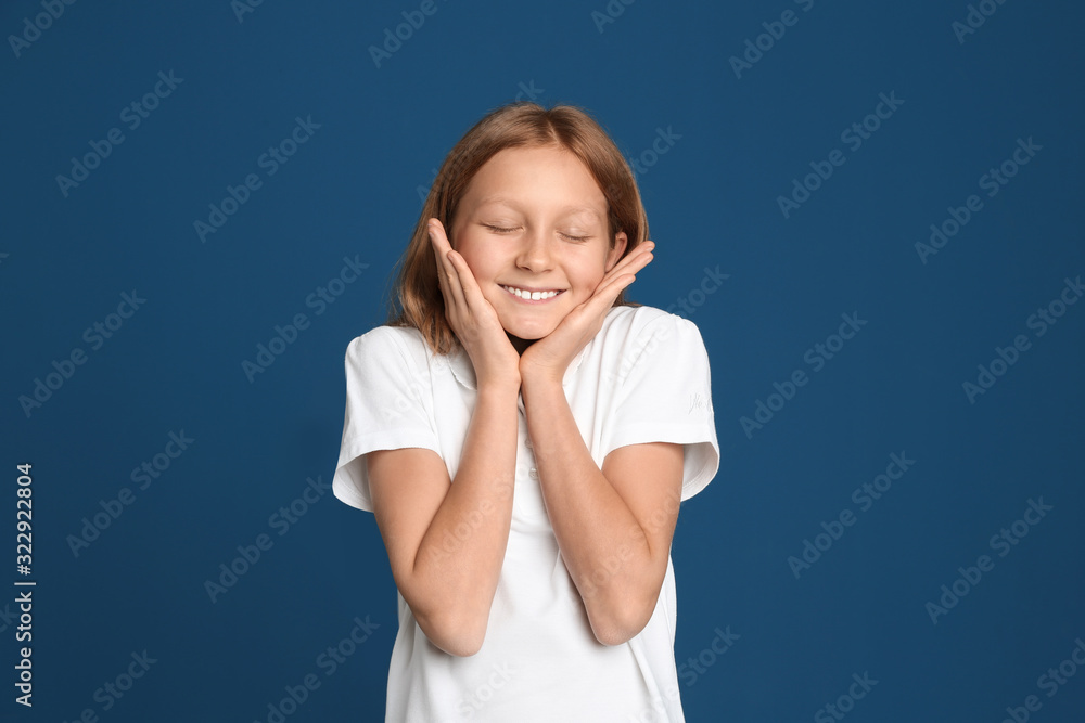 Portrait of emotional preteen girl on blue background Portrait of emotional preteen girl on blue background