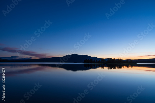 Tranquil dusk reflected in a lake in Scandinavia. Sweden.