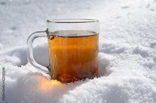 Glass Tea Cup In Snow in Morning Winter Mood Christmas