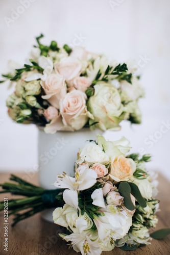  Beautiful bouquets of white and pink roses in a vase on the table. Wedding accessories