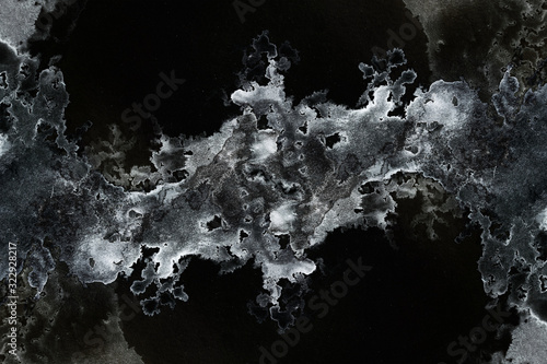 abstract splashes on black background. monochrome image.