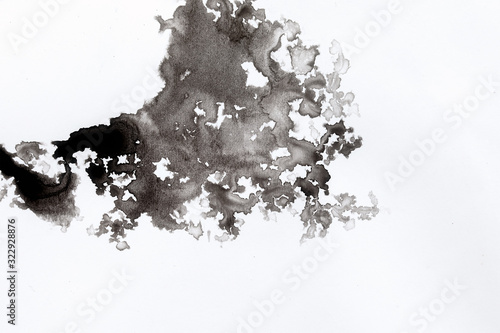 abstract black splashes on white watercolor paper. monochrome image.