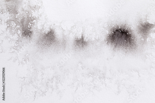 abstract black splashes on white watercolor paper. monochrome image.