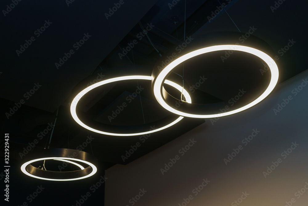 Black design details of the modern device ceilings in the room. Lighting design, lamps and fixtures. Black design details of the modern device ceilings in the room. Lighting design, lamps and fixtures.