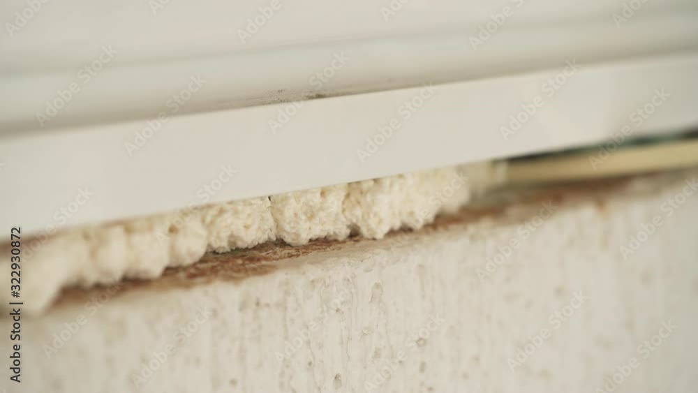 Using polyurethane foam to fill gaps during installing a window. Stock