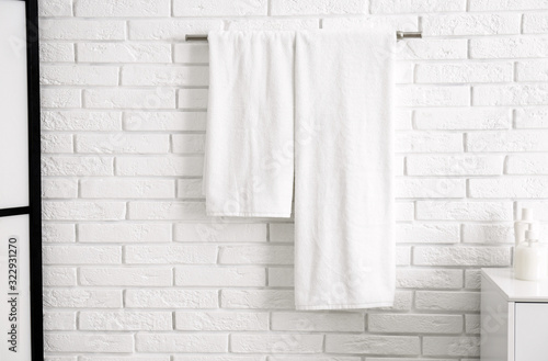 Fresh clean towels on hanger in bathroom