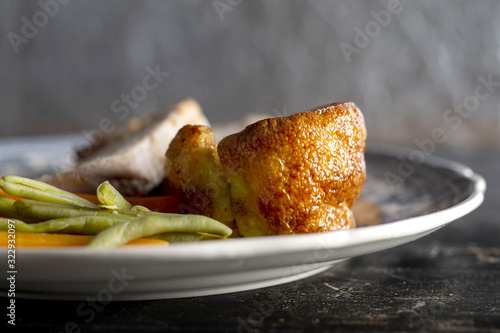 Schilderij op canvas Yorkshire pudding on a plate with meat and vegetables