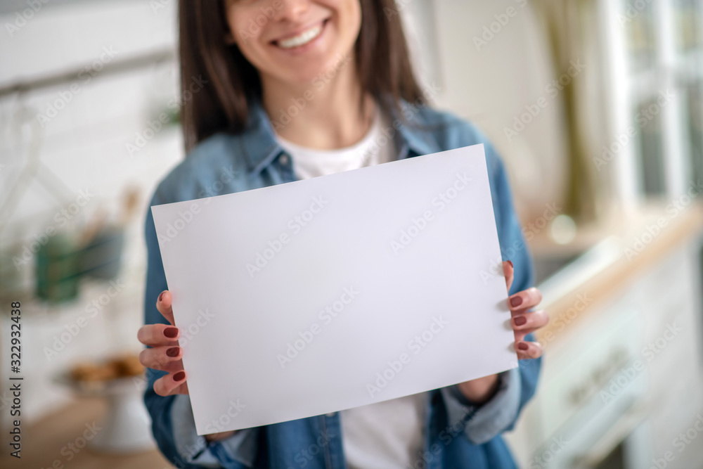 Woman holding a white paper sign template Woman holding a white paper sign template