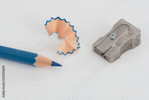 Blue pencil, sharpener and shaving isolated on white background