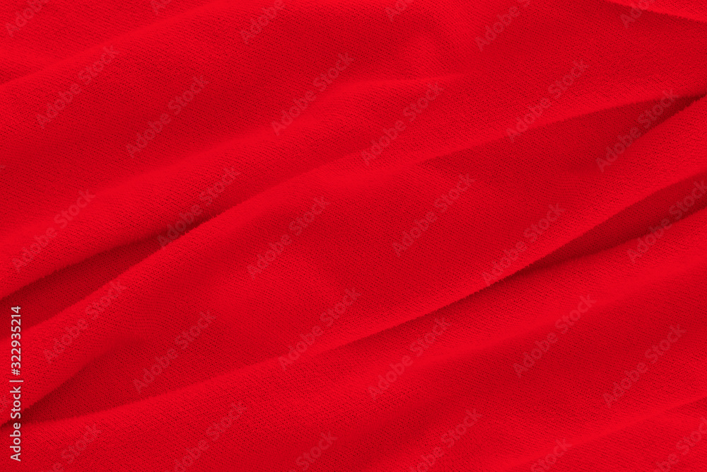 Red fabric texture background. Abstract cloth backdrop with soft waves. Red fabric texture background. Abstract cloth backdrop with soft waves.