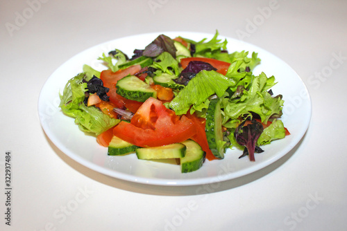 Green salad , organic kalamata olives, juicy tomatoes, red pepper, red onion, cucumber and lettuce. Concept for healthy nutrition. Tasty and healthy vegetarian meal. Close up.