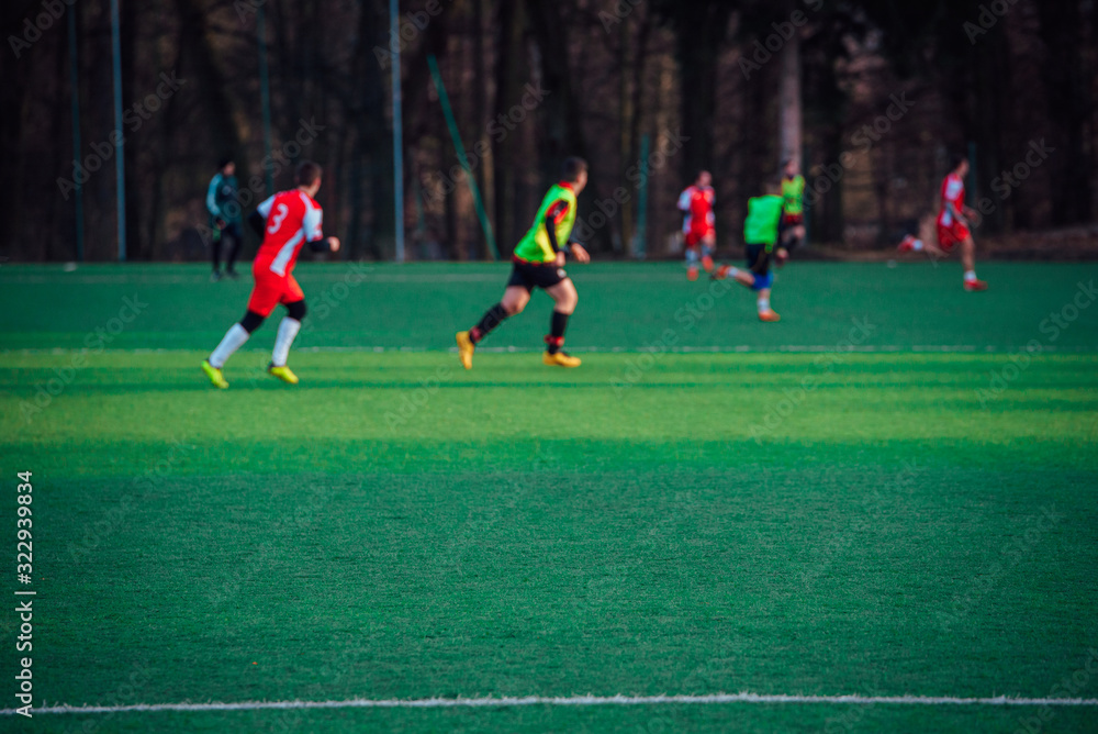 Football players on the green pitch, blurred background Football players on the green pitch, blurred background