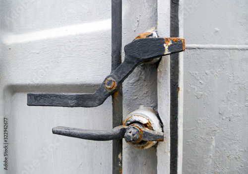 Mechanical lock on a sealed ship door photo