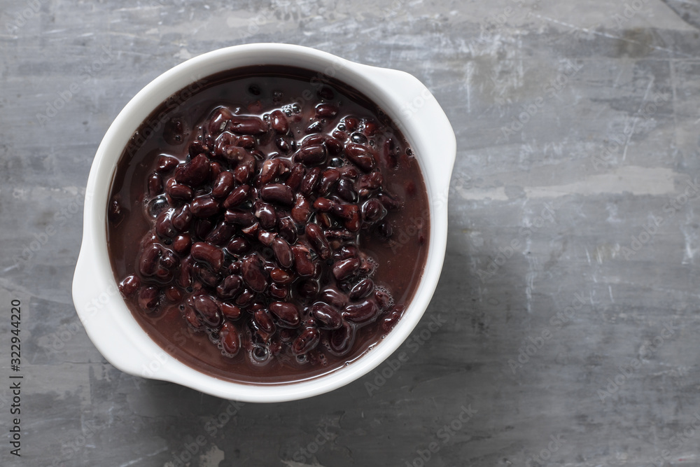boiled black beans in white bowl on ceramic background boiled black beans in white bowl on ceramic background