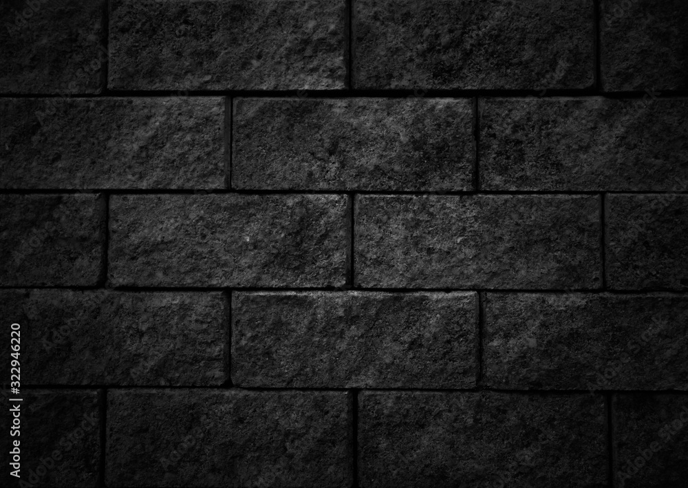 Black wall as background, texture of a black brick wall.Black slate wall. Black wall as background, texture of a black brick wall.Black slate wall.