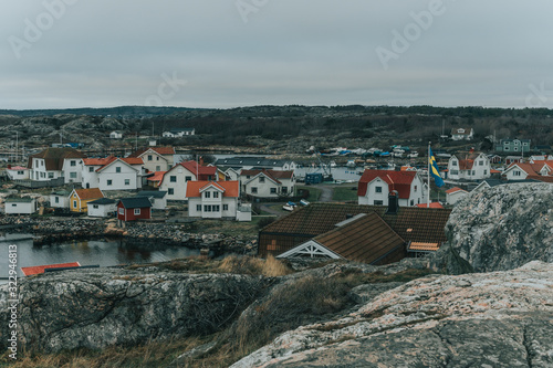 Vrångö, Southern Gothenburg Archipelago / Sweden - A view of sea shore, a rocky landscape of Vrångö island and its scandinavian wooden houses in Sweden during a cloudy day.