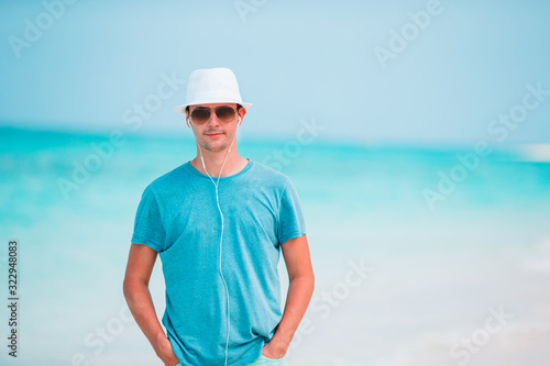 Young man on the white tropical beach