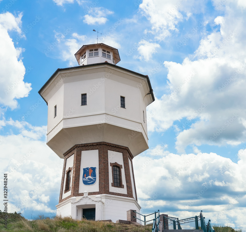 A lighthouse and water tower at the island of Langeoog, East Frisian islands, Lower Saxony, Germany A lighthouse and water tower at the island of Langeoog, East Frisian islands, Lower Saxony, Germany