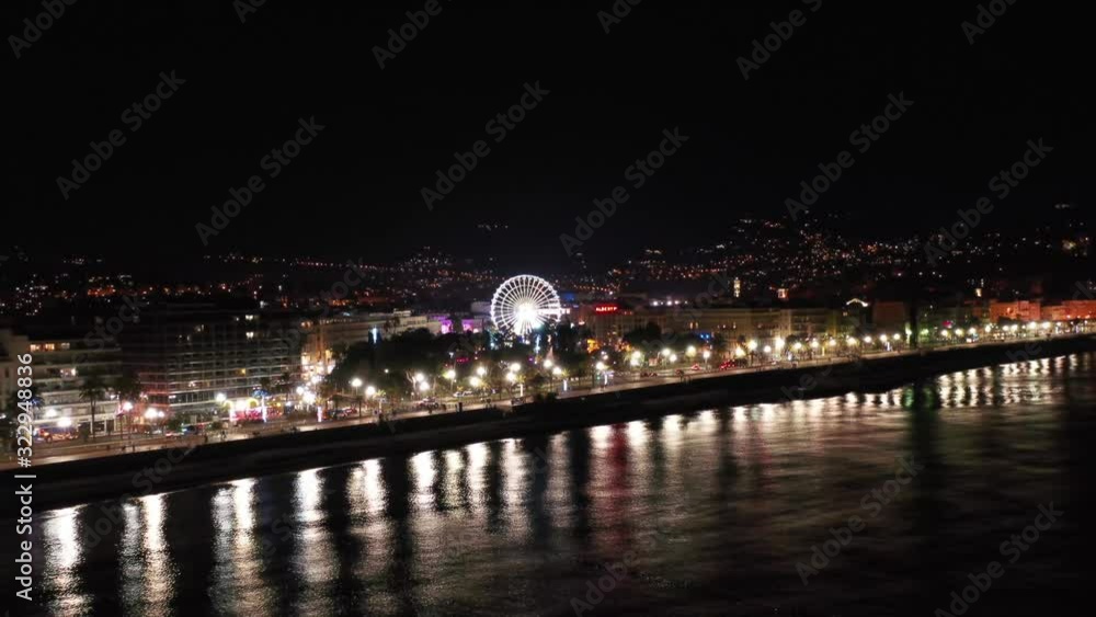 Ferris wheel and attractions in center of the Nice city, France at night during Christmas market Ferris wheel and attractions in center of the Nice city, France at night during Christmas market