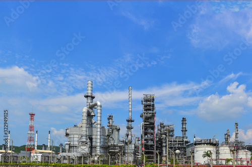 Oil and gas industrial, Oil refinery plant from industry, Refinery Oil storage tank and pipe line steel with blue sky and white clouds background.