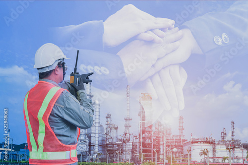 worker in oil refinery plant and hand pointing to target success on hand stacking, Technician Industrial workers with walkie-talkie in a power plant for investment industry concept.
