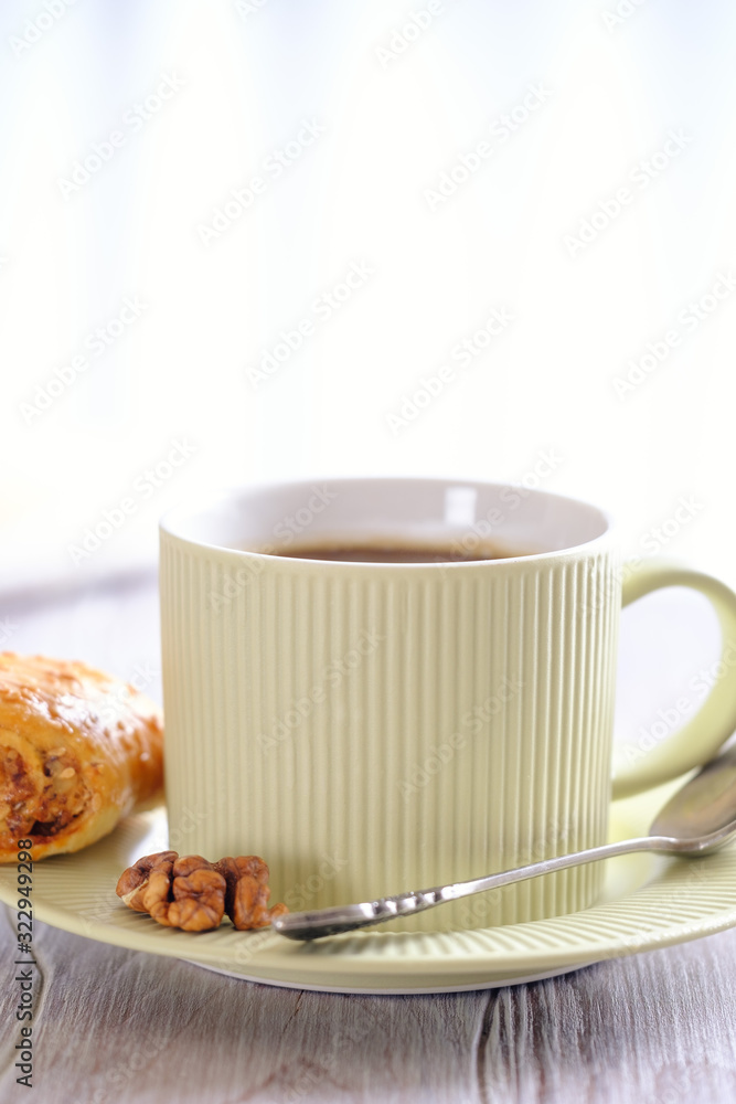 Fresh and rouge rolls with nuts, raisins and meringues on a wooden table and a cup with aromatic coffee Fresh and rouge rolls with nuts, raisins and meringues on a wooden table and a cup with aromatic coffee