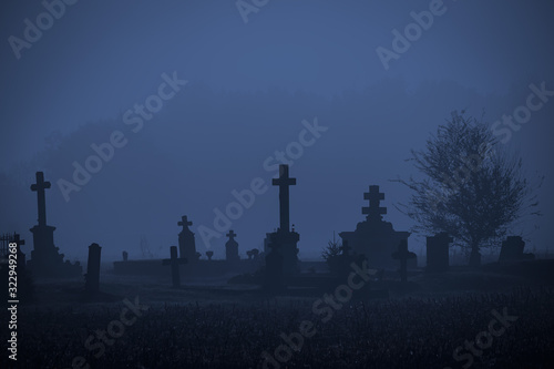 Graveyard in fog photo