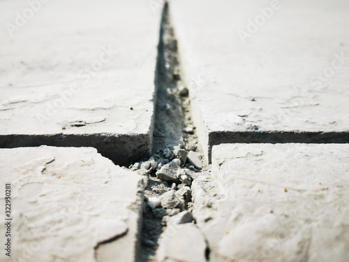 space in concrete floor, expansion joint or movement joint is an assembly designed, pipelines expand and contract due to warming and cooling from seasonal variation, photo is Depth of field style