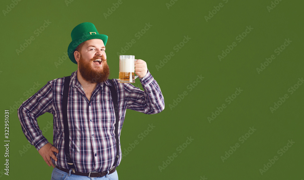 Happy St. Patrick's Day. Fat man in a green hat holds his hands up glasses with beer Happy St. Patrick's Day. Fat man in a green hat holds his hands up glasses with beer