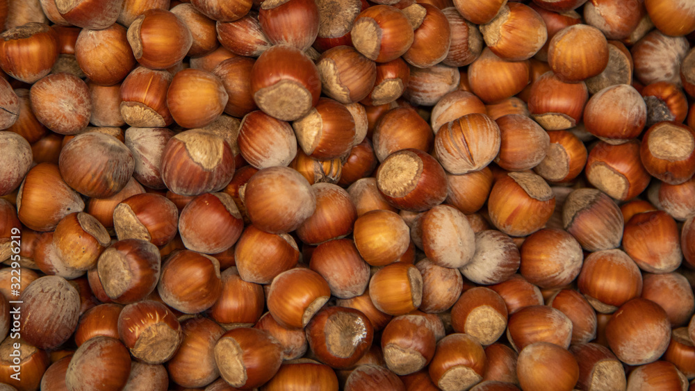 Hazelnut on store shelves and the buyer's hand with a shovel Hazelnut on store shelves and the buyer's hand with a shovel