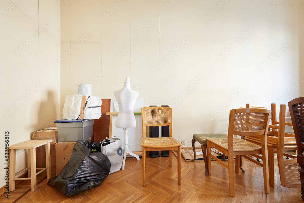 Fototapeta premium Room with chairs, boxes and a tailor dummy before moving house