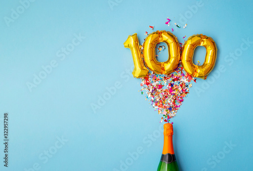 100th anniversary champagne bottle balloon pop photo