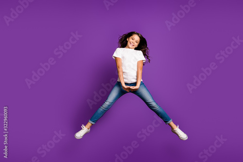 Full length body size view of her she nice attractive lovely cheerful cheery girlish wavy-haired girl jumping having fun isolated on bright vivid shine vibrant purple violet lilac color background