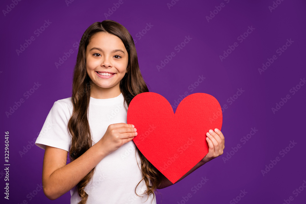 Close-up portrait of her she nice attractive lovely lovable cheerful wavy-haired girl holding in hand big large heart symbol isolated on bright vivid shine vibrant purple violet lilac color background Close-up portrait of her she nice attractive lovely lovable cheerful wavy-haired girl holding in hand big large heart symbol isolated on bright vivid shine vibrant purple violet lilac color background