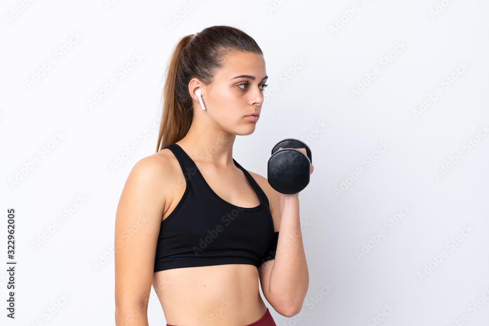 Teenager sport girl over isolated white background making weightlifting Teenager sport girl over isolated white background making weightlifting