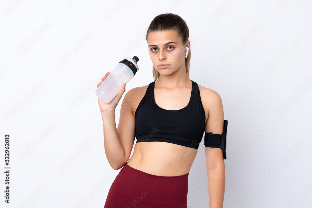 Teenager sport girl over isolated white background with sports water bottle Teenager sport girl over isolated white background with sports water bottle