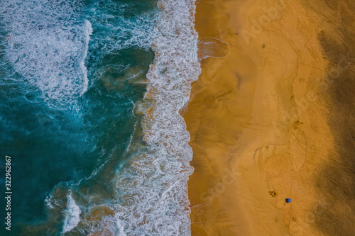 Sea water meeting white sand beach - aerial view. Fuerteventura island, Canary, Spain. October 2019