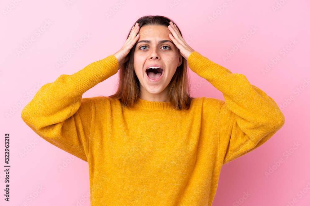 Teenager girl with yellow sweater over isolated pink background with surprise expression Teenager girl with yellow sweater over isolated pink background with surprise expression