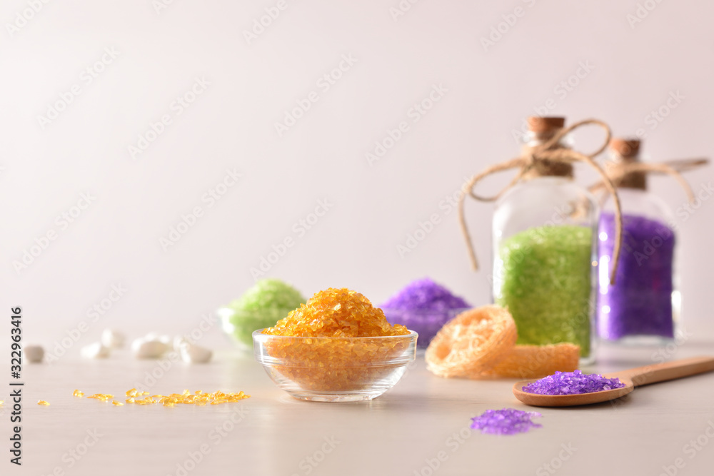 Bath salts in containers on wood table isolated white background
