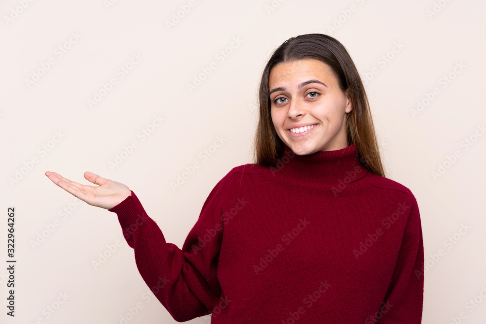 Teenager girl over isolated background extending hands to the side for inviting to come Teenager girl over isolated background extending hands to the side for inviting to come