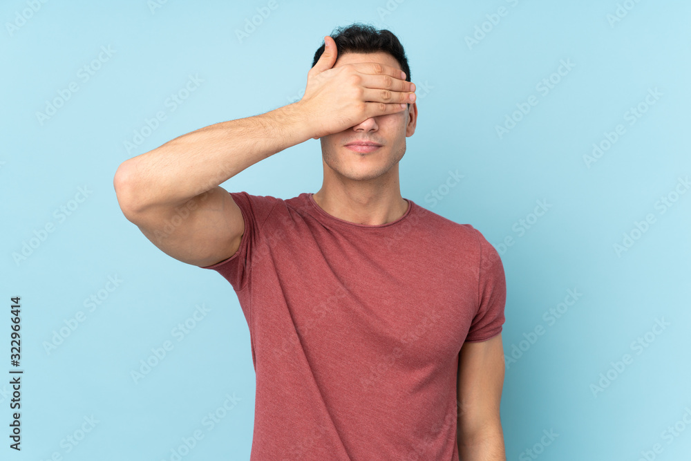 Young caucasian handsome man isolated on blue background covering eyes by hands. Do not want to see something Young caucasian handsome man isolated on blue background covering eyes by hands. Do not want to see something